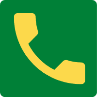 Żółty telefon na zielonym tle.